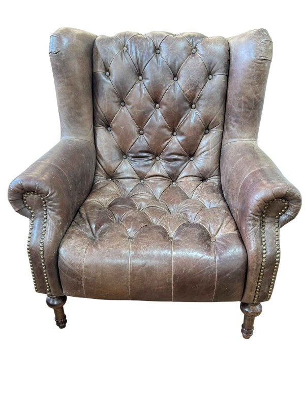 Alexander & James tan buttoned leather and studded wing armchair.