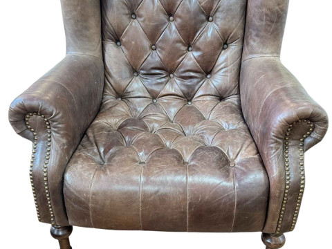 Alexander & James tan buttoned leather and studded wing armchair.