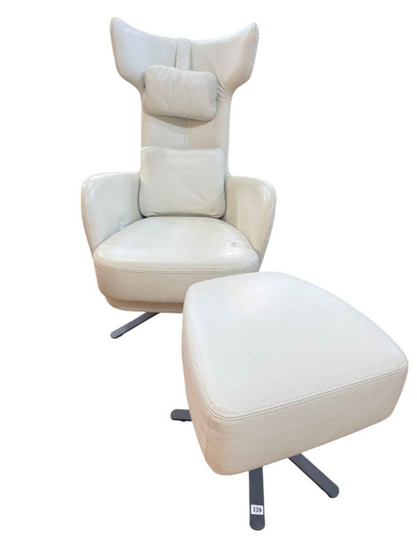 Fama, Spain, contemporary white leather swivel armchair and footstool.