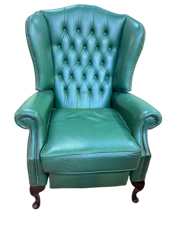 Green buttoned leather and studded wing back reclining armchair.