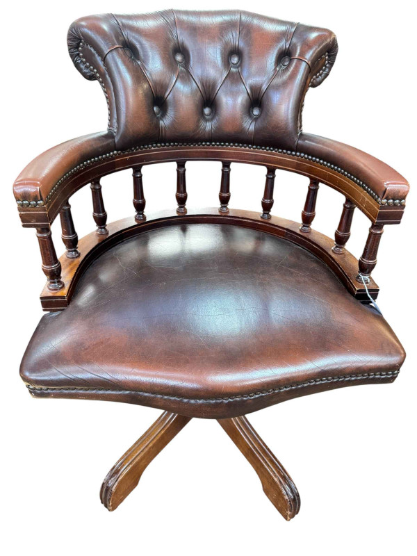Brown buttoned leather captains style swivel office desk chair.