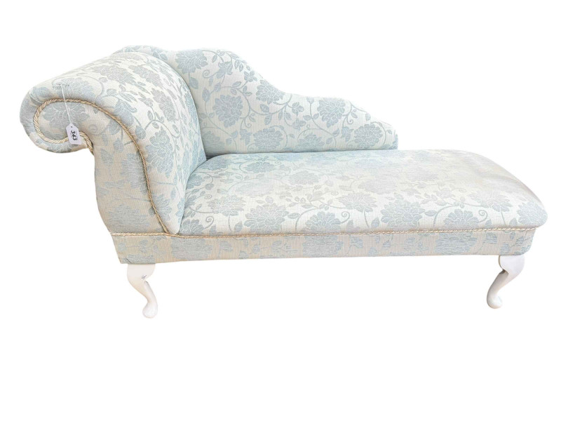 Contemporary chaise longue in light blue floral fabric.