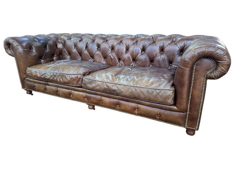 Halo brown buttoned leather three seater Chesterfield settee, 78cm by 241cm by 95cm.