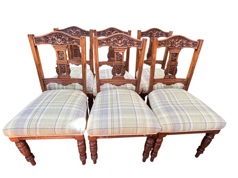 Set of six Edwardian carved oak dining chairs in tartan fabric.