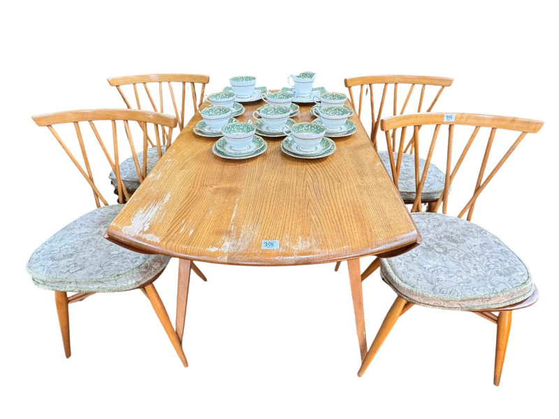 Vintage Ercol Windsor six piece dining suite comprising three door sideboard, drop leaf dining table and set of four Windsor candlestick dining chairs, together with an open plate rack.