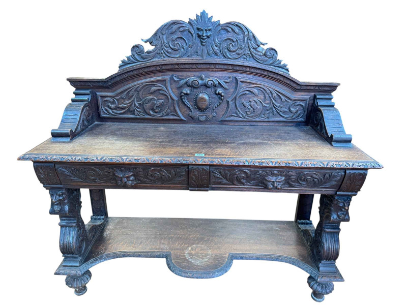 Victorian carved oak buffet having two lion mask carved drawers and shaped undershelf, 120.5cm by 123cm by 46cm.