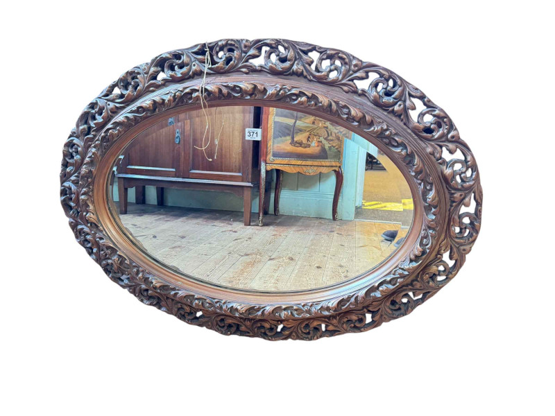 Oval gilt framed bevelled wall mirror, 66cm by 92cm.