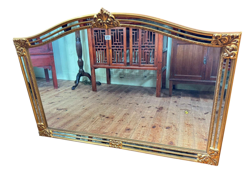 Gilt framed arched top overmantel mirror, 90cm by 128cm.
