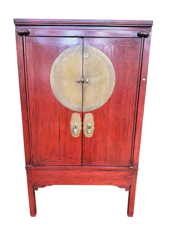 Chinese red lacquered two door wedding cabinet having two internal drawers, 176cm by 102cm by 66cm.