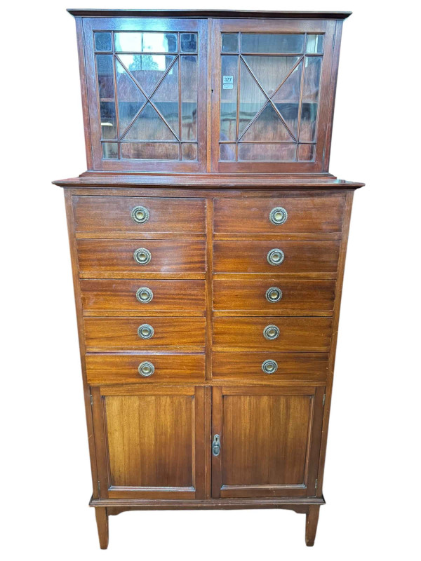 Edwardian mahogany cabinet having two astragal glazed doors above two banks of five drawers with two cupboard doors below, 186cm by 87cm by 47.5cm.
