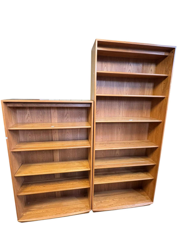 Two Ercol open bookcases both with adjustable and fixed shelves, largest 213cm by 91cm by 31cm.