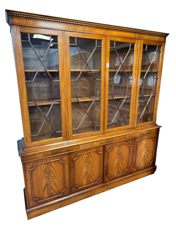Mahogany cabinet bookcase having four astragal glazed doors enclosing adjustable shelves above four cupboard doors, 191cm by 183cm by 37cm.