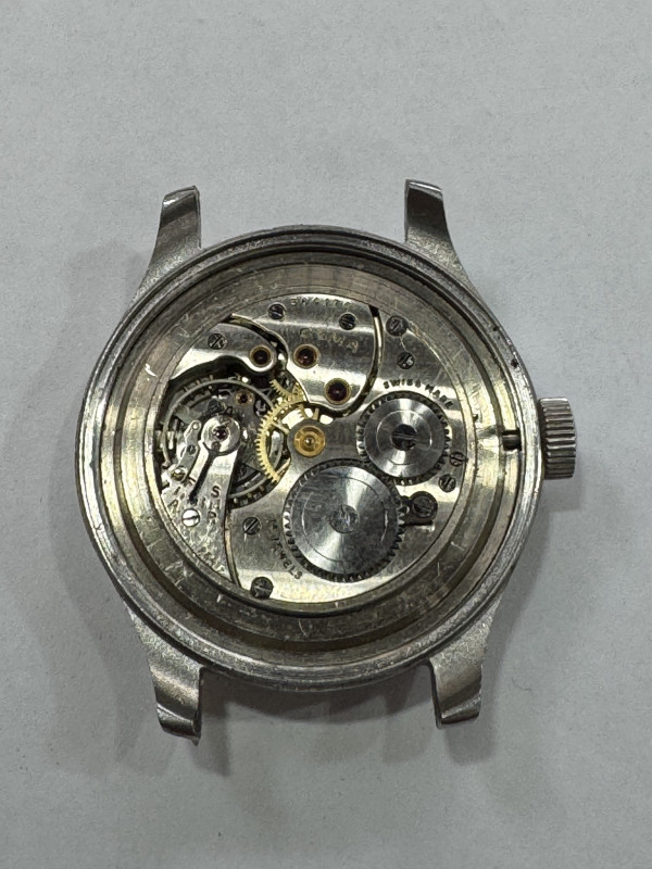 Two boxes of pocket and wristwatches including CYMA WWII military issue steel wristwatch, costume jewellery, lighters, etc.