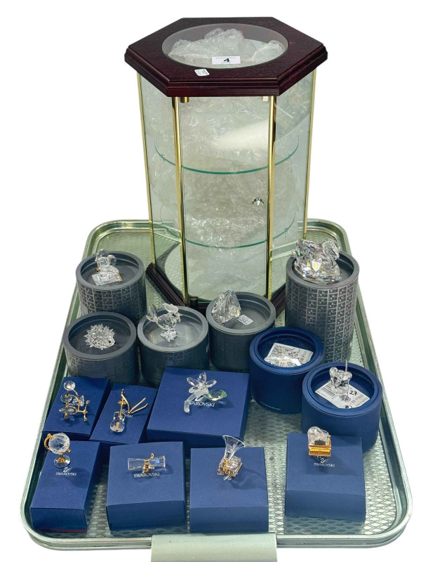 Collection of boxed Swarovski ornaments and hexagonal display cabinet.