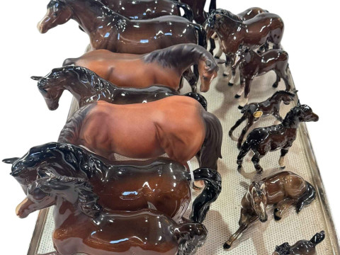 Fifteen Beswick and Royal Doulton horses and foals.