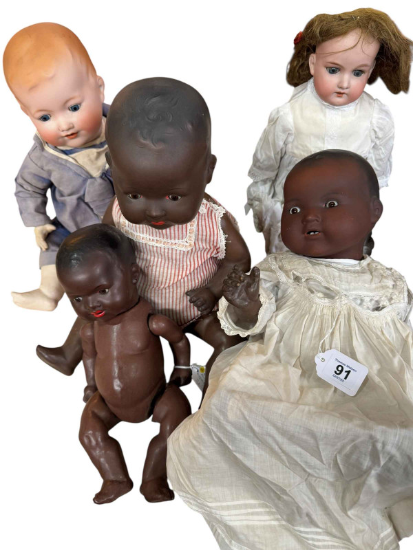 Five Armand Marseille bisque head dolls including three black dolls.