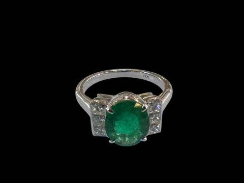 Emerald and diamond ring set in 18 carat white gold, the oval emerald...