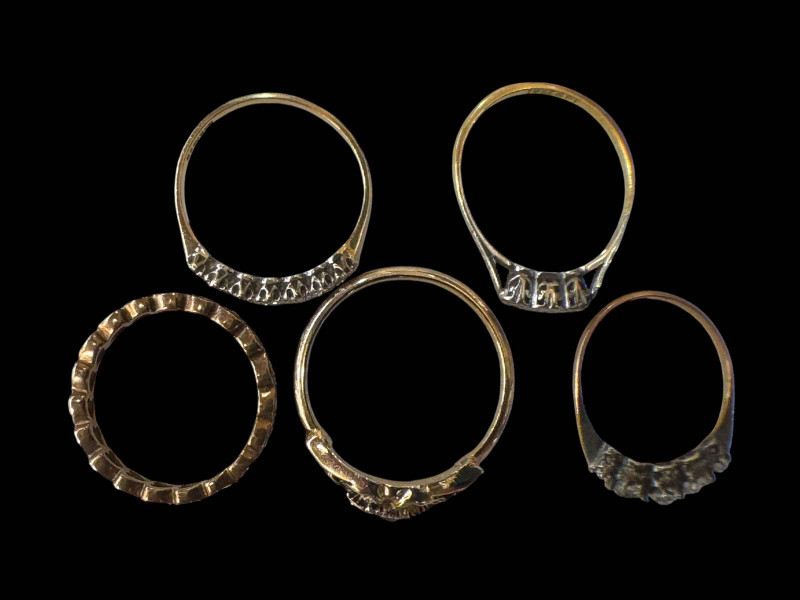Collection of five rings, some gold.
