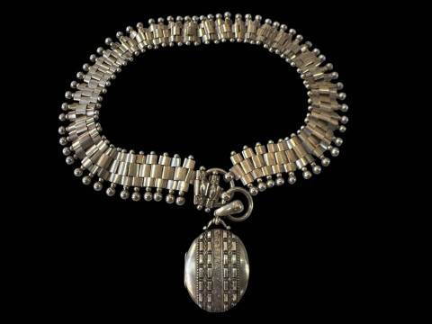 Silver collar necklace with locket.