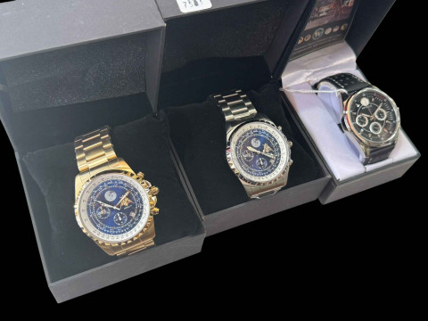 Three Apollo wristwatches.