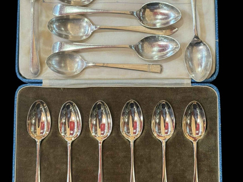 Cased set of silver teaspoons, silver pickle fork and other teaspoons.