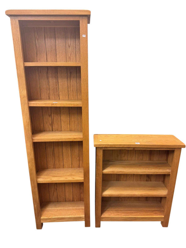 Two light oak open bookcases, largest 170cm by 52cm by 22.5cm.