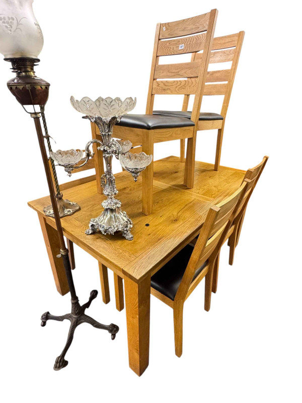 Rectangular light oak dining table and set of six ladder back dining chairs.