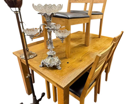 Rectangular light oak dining table and set of six ladder back dining chairs.