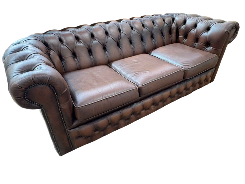 Brown deep buttoned leather and studded three seater Chesterfield settee, 65cm by 188cm by 83cm.