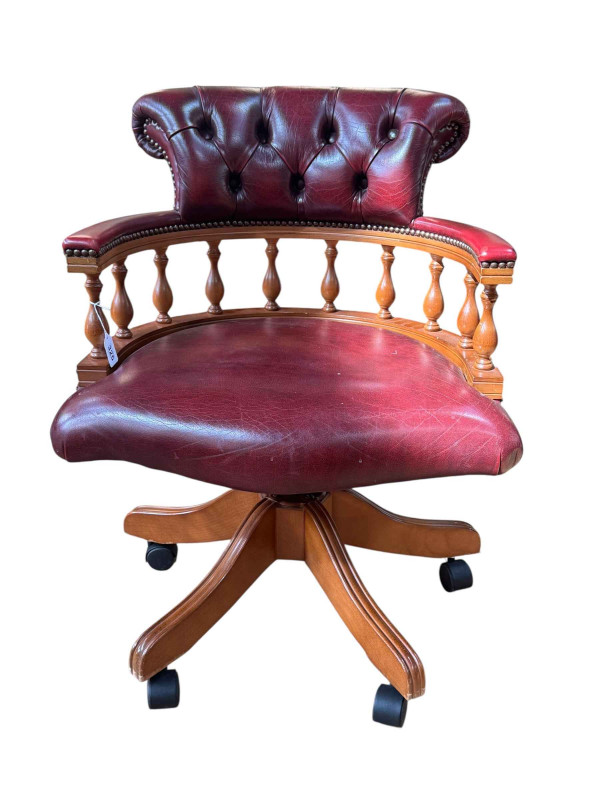 Ox blood buttoned leather captains style swivel desk chair.
