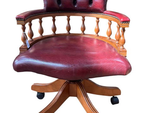 Ox blood buttoned leather captains style swivel desk chair.