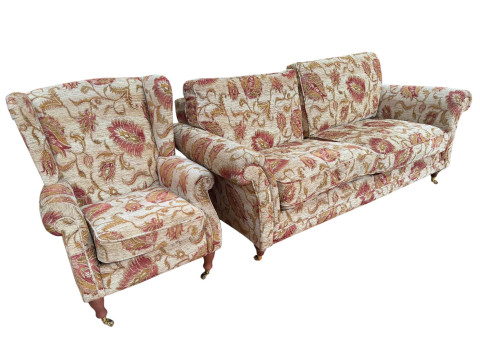 Parker Knoll settee and wing armchair in floral pattern fabric.