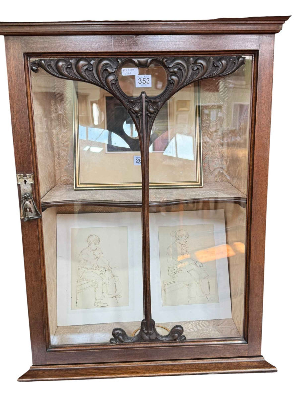 Art Nouveau mahogany cabinet, the canopied top having central glazed panel door flanked by two shaped shelves above two coloured leaded glass panel doors, 183.5cm by 138cm by 46cm.