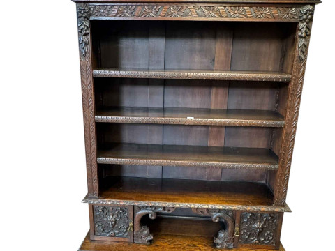Victorian carved oak open bookcase having three adjustable shelves above...