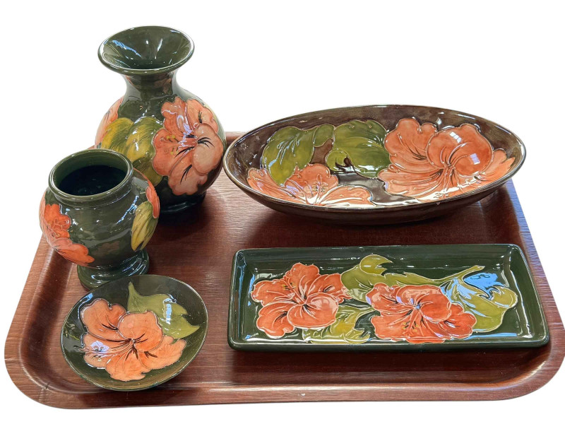 Five pieces of Moorcroft Pottery decorated with hibiscus, two vases, oval dish, pin dish and tray.