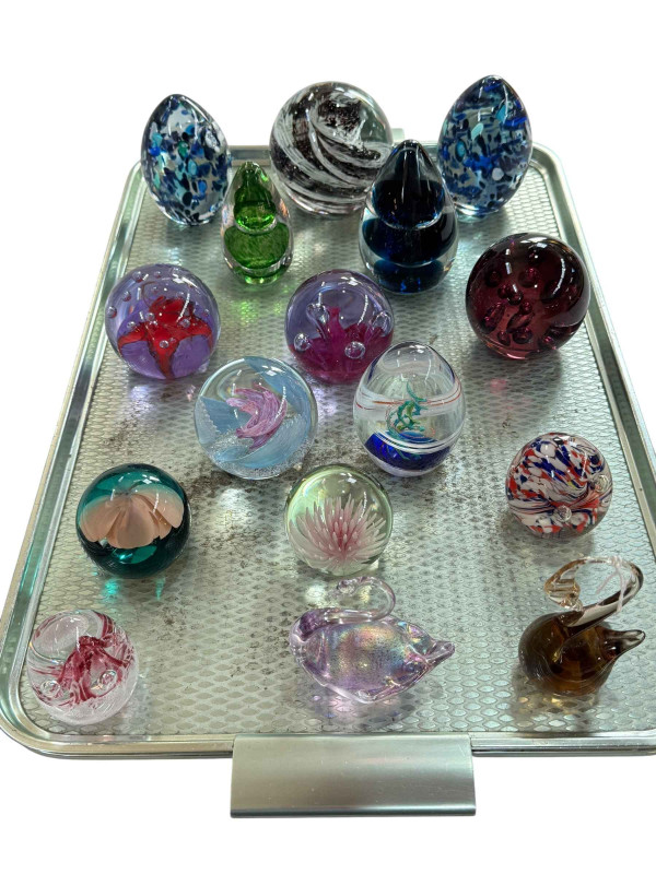 Collection of sixteen glass paperweights including Caithness.