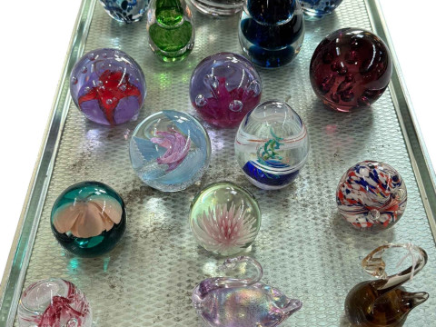 Collection of sixteen glass paperweights including Caithness.