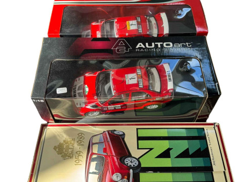 Four boxed model vehicles including two Tommi Mäkinen Mitsubishi Lancers,...