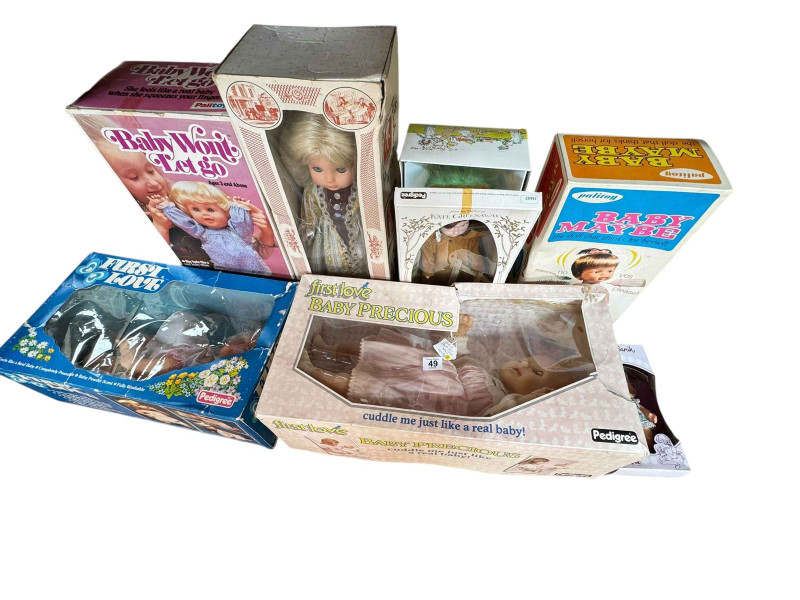 Seven assorted boxed dolls including two First Love, Baby Wont Let Go and Pedigree dolls.