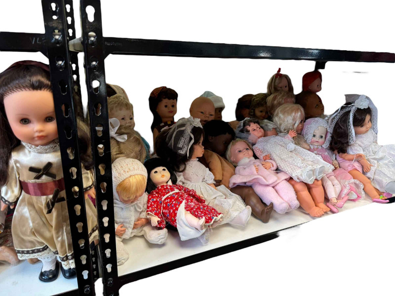 Full shelf of Mid 20th Century to present dolls.
