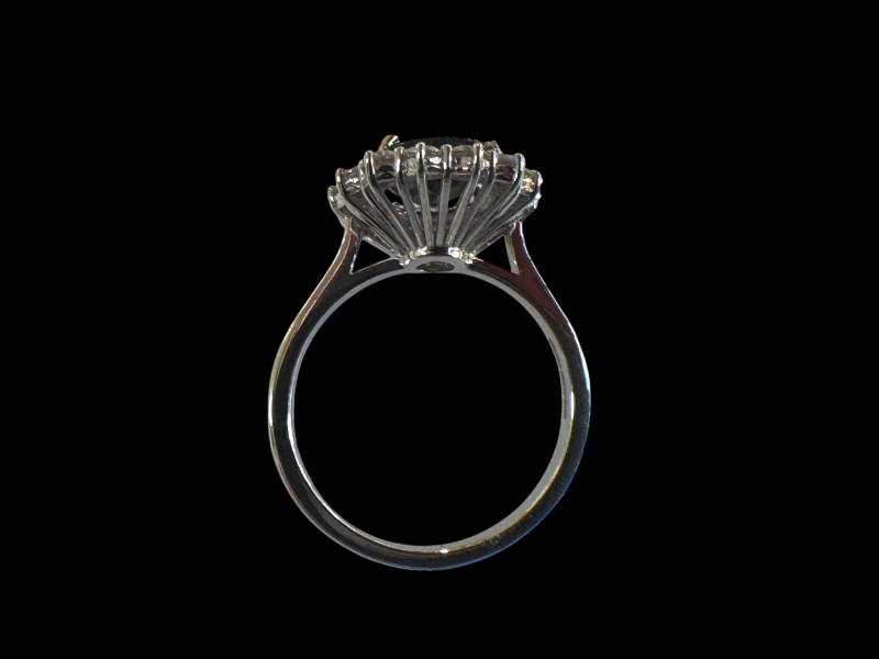 18 carat white gold, sapphire and diamond cluster ring, the centre oval sapphire 2.20 carats, size N.