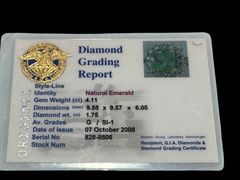 Good quality natural emerald and diamond cluster ring set in 18 carat white gold with yellow shank, size Mœ, with diamond grading report.