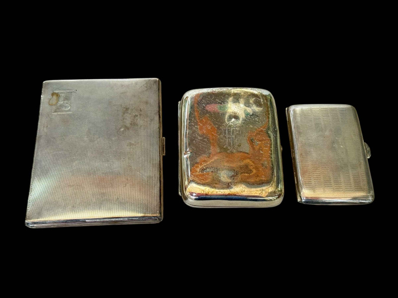 Three silver cigarette cases.