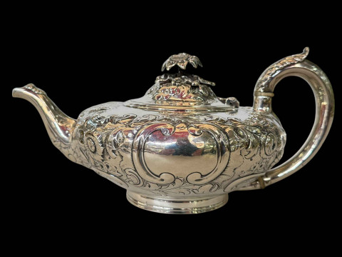 Victorian silver teapot with embossed scrolling foliage and cast flower...