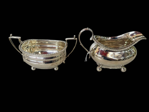 Silver sugar basin and cream jug with gadroon borders, George IV and 1920's.