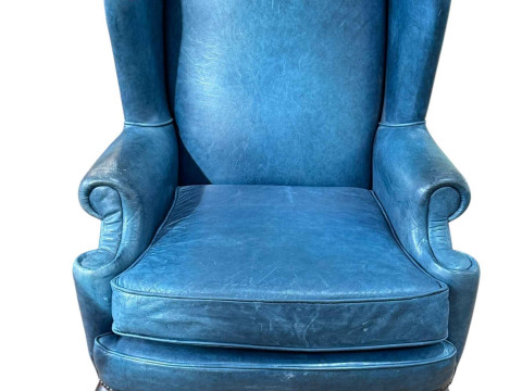 Blue leather and studded wing back armchair on cabriole legs.