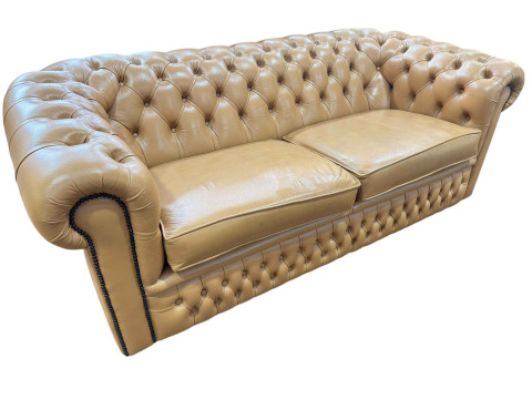 Tan deep buttoned leather and studded three seater Chesterfield settee,...
