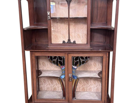 Art Nouveau mahogany cabinet, the canopied top having central glazed panel...
