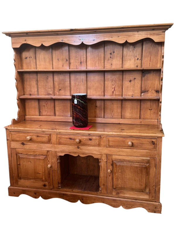 Pine dresser, the shelf back above three drawers with a central open compartment and two cupboard doors below, 194cm by 185.5cm by 43cm.