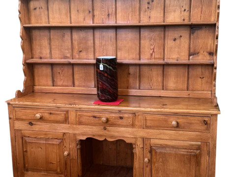 Pine dresser, the shelf back above three drawers with a central open compartment...